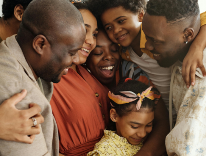 Group hug of a smiling family, showing love and joy.